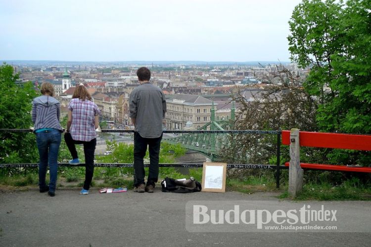 Halfway to the top of Gellert hill, bird's-eye view of the bridge and Market Hall. Young artists often sketch and draw here, while tourists take photos. Gellert Hill, Budapest