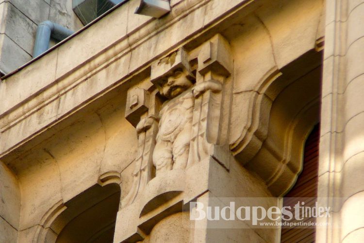 The building has quite stern ornamentation reminding of German architecture with tough-looking lions, men and child figures.